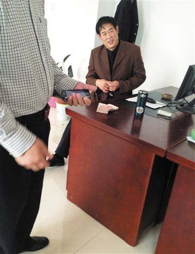 10月29日，獻(xiàn)縣國稅局稽查局辦公室內(nèi)，一名企業(yè)主交了兩萬元現(xiàn)金在桌上。新京報記者 孟祥超 攝
