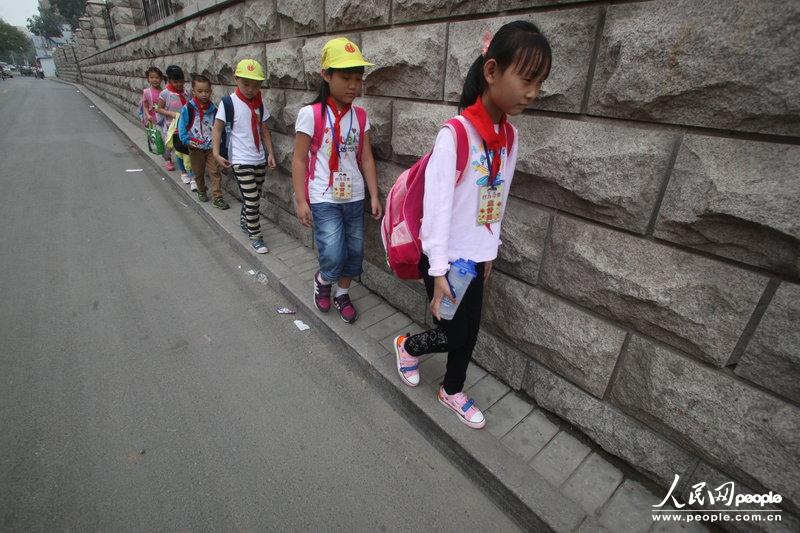 2013年09月11日，濟南運署街上，小學(xué)生走史上“最窄人行道”上學(xué)。圖片來源：CFP