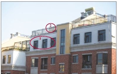 中海城香克林小區(qū),楊智家的樓頂上加蓋了兩層違建。其中北側露臺建成了一層灰白色的房屋(①)。在該違建頂部的東側,又加蓋了一層面積較小的房屋(②)。新京報記者 韓萌 攝