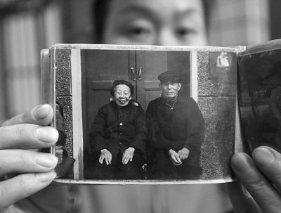 圖為孫女拿出兩位老人上世紀80年代在家門口的合影給記者看。記者楊濤 攝
