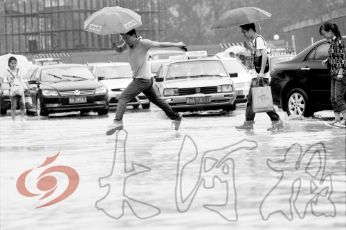 鄭州經(jīng)三路與北環(huán)交叉口處，積水較深，行人們不得不“練輕功”。 記者 白周峰 攝影