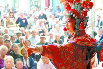 圖為8月15日戲曲演員在“流動(dòng)舞臺(tái)車”上表演傳統(tǒng)地方戲《穆桂英下山》。