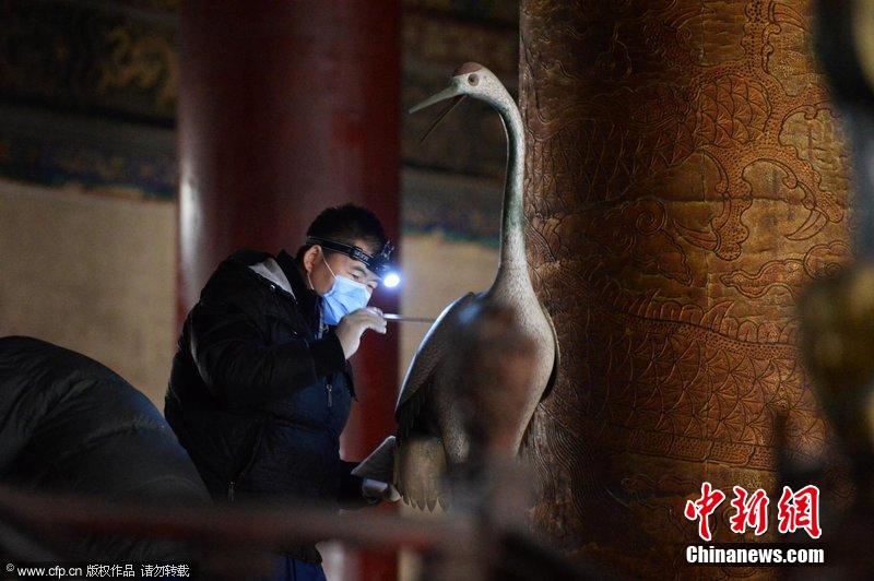 圖為工作人員使用軟毛刷除塵。