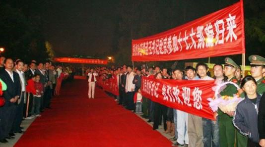 “夾道歡迎”中不少人打出橫幅，路上被鋪上了紅毯。