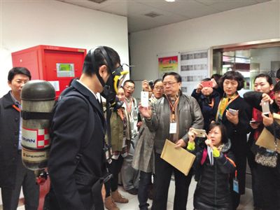 昨天，地鐵4號(hào)線北京南站站，地鐵工作人員為人大代表演示應(yīng)急氧氣瓶佩戴方式。新京報(bào)記者