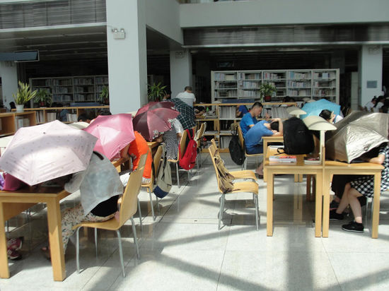 圖書館內(nèi)撐傘讀書的民眾。