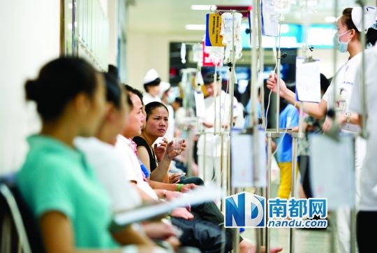 醫(yī)院走道坐滿了打吊針的員工。