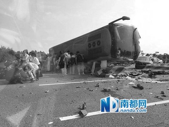 現(xiàn)場大客車側(cè)翻，玻璃碎落一地，車身卡在路邊水泥護欄上。 目擊者供圖